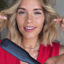 Woman with blonde short hair styling soft waves with The Contouring Wide Iron
